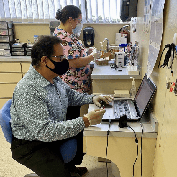 Two people in a lab working on hearing aids.